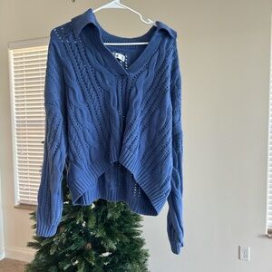 Blue knitted sweater with a collar